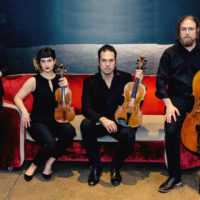 String quartet posing on a couch