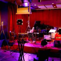 A jazz performance space with tripods and cameras set up