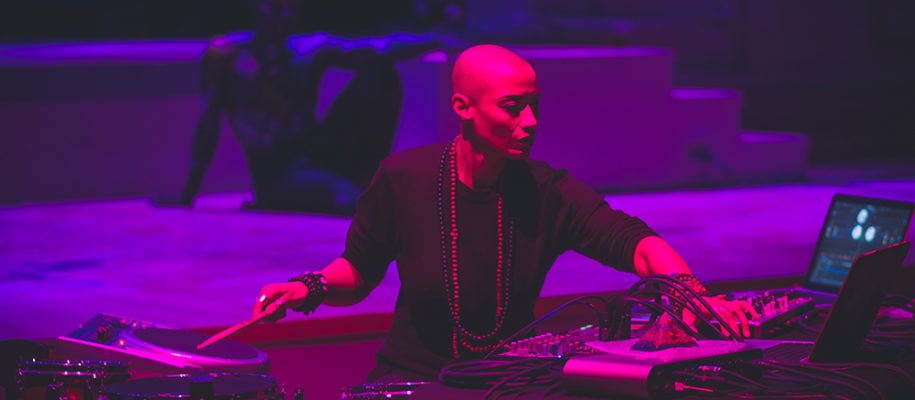 Val Jeanty operating electronic music equipment in a performance (Photo by Wolf Daniel)