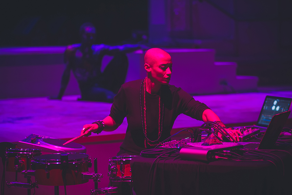 Val Jeanty operating electronic music equipment in a performance (Photo by Wolf Daniel)