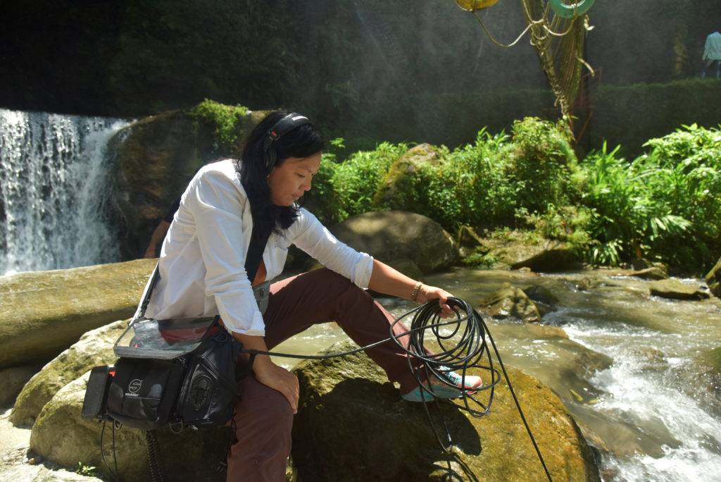 Susie Ibarra recording water with a hydrophone (photo by Rajesh Kumar Singh)