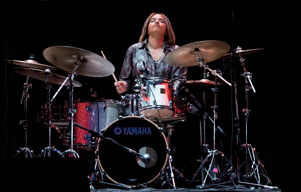 Terri Lyne Carrington behind a drum set.
