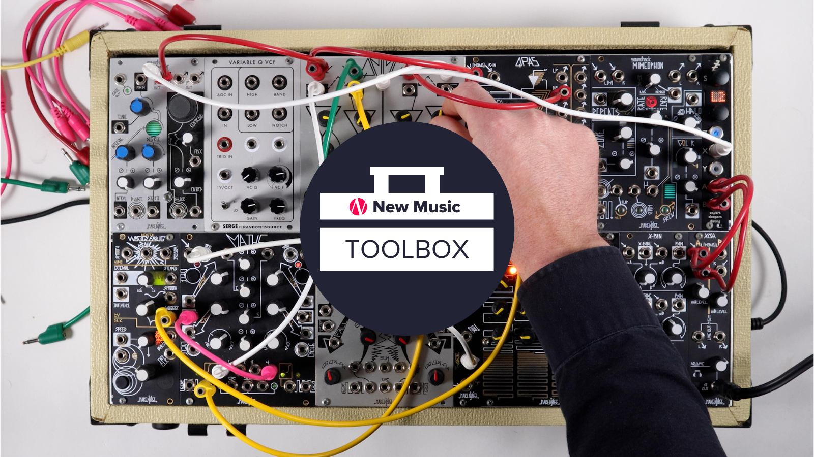 A hand manipulating a patch cord on a synthesizer with lots of patches and an overlay of the New Music Toolbox logo