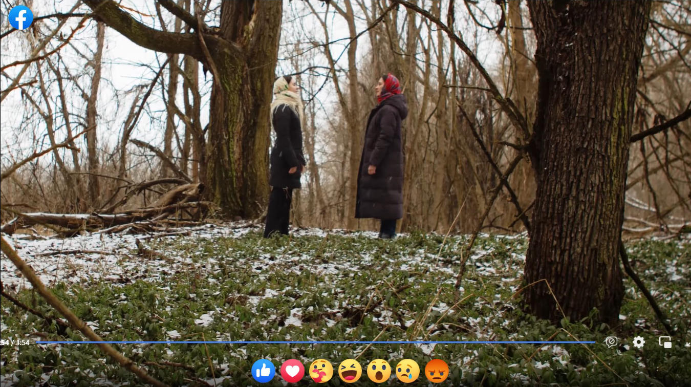 Two women are facing each other in the middle of a forest in this still from a video posted on Iryna Danylejko's Facebook wall