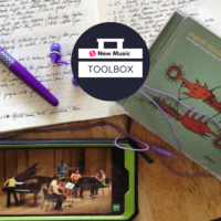 A pen and a notebook with handwritten notes, a CD and a smartphone with a display of a video of music performance overlayed with the New Music Toolbox logo