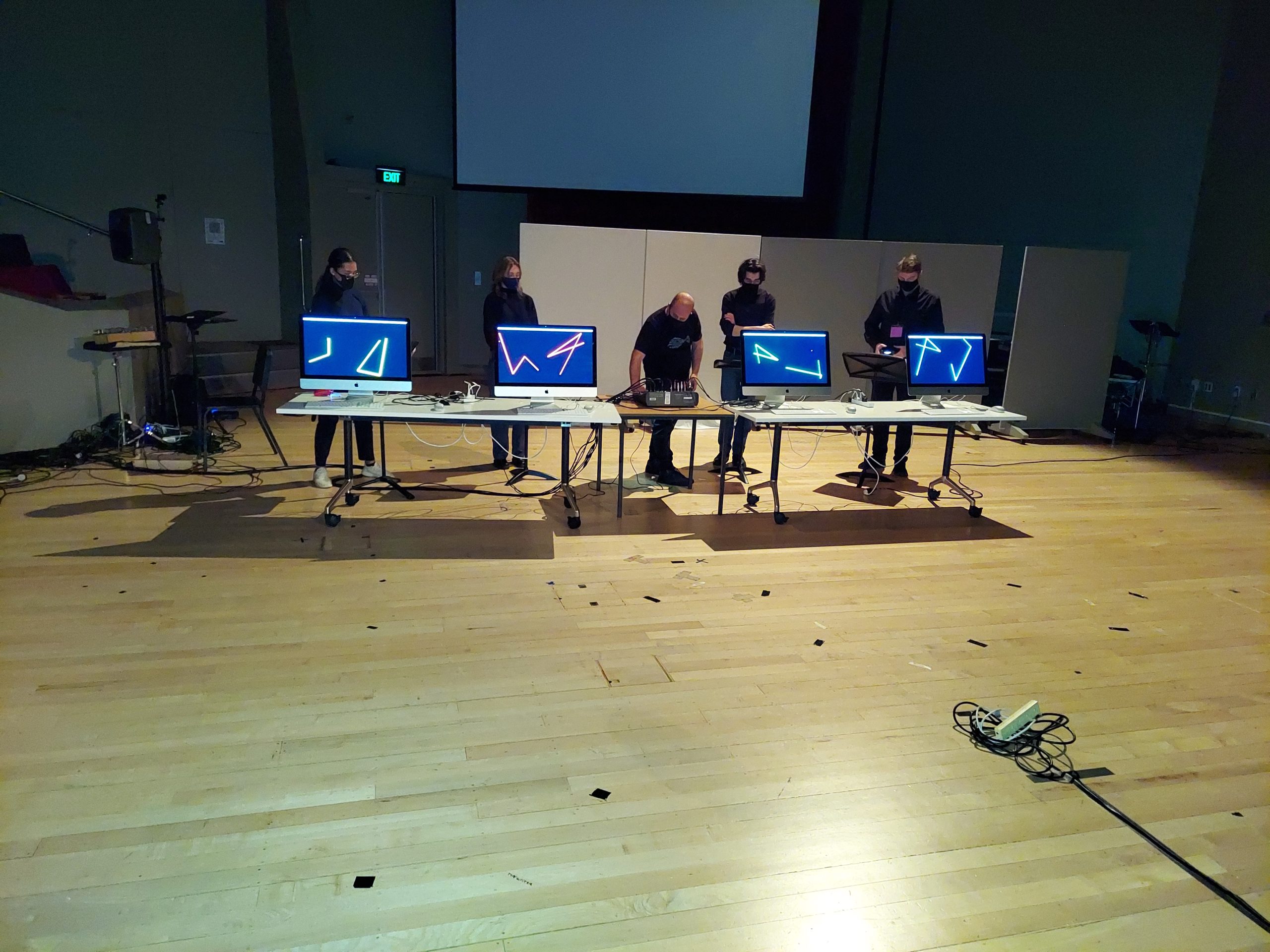Computer terminals with visuals and audio triggered by 4 PlayStation controllers during a performance of Joo Won Park's PS Quartet No. 1 