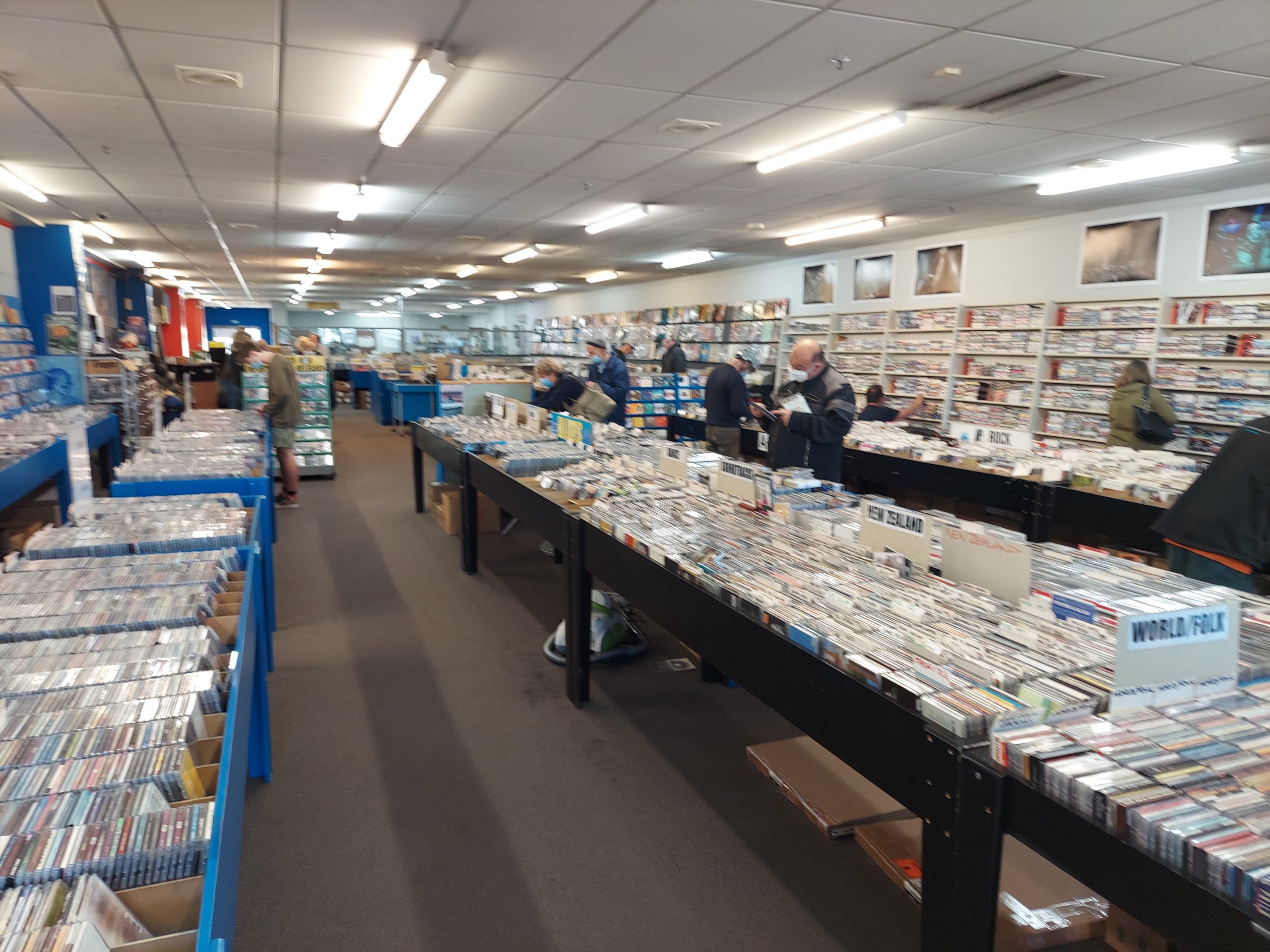 Tables filled with CDs and tables filled with LPs further in the back.