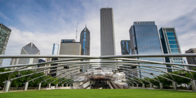 CHICAGO,USA-AUGUST 12,2013:Jay Pritzker Pavilion at the millenium park in Chigago in a sunny day with chicago skyline on background