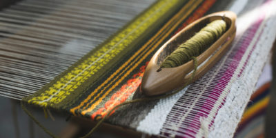 Vintage loom and yarn. Knitting carpet
